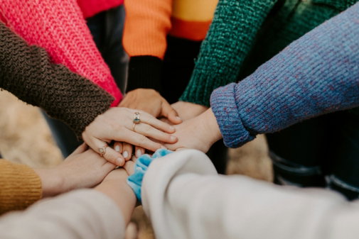 person-in-red-sweater-holding-babys-hand.jpg person in red sweater holding babys hand